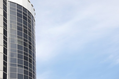 Modern building with tinted windows against sky. Urban architecture