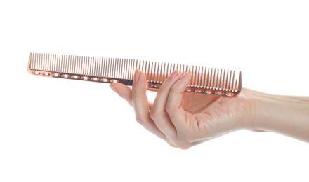 Woman holding hair comb on white background, closeup