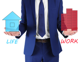 Businessman showing balance between life and work on white background, closeup