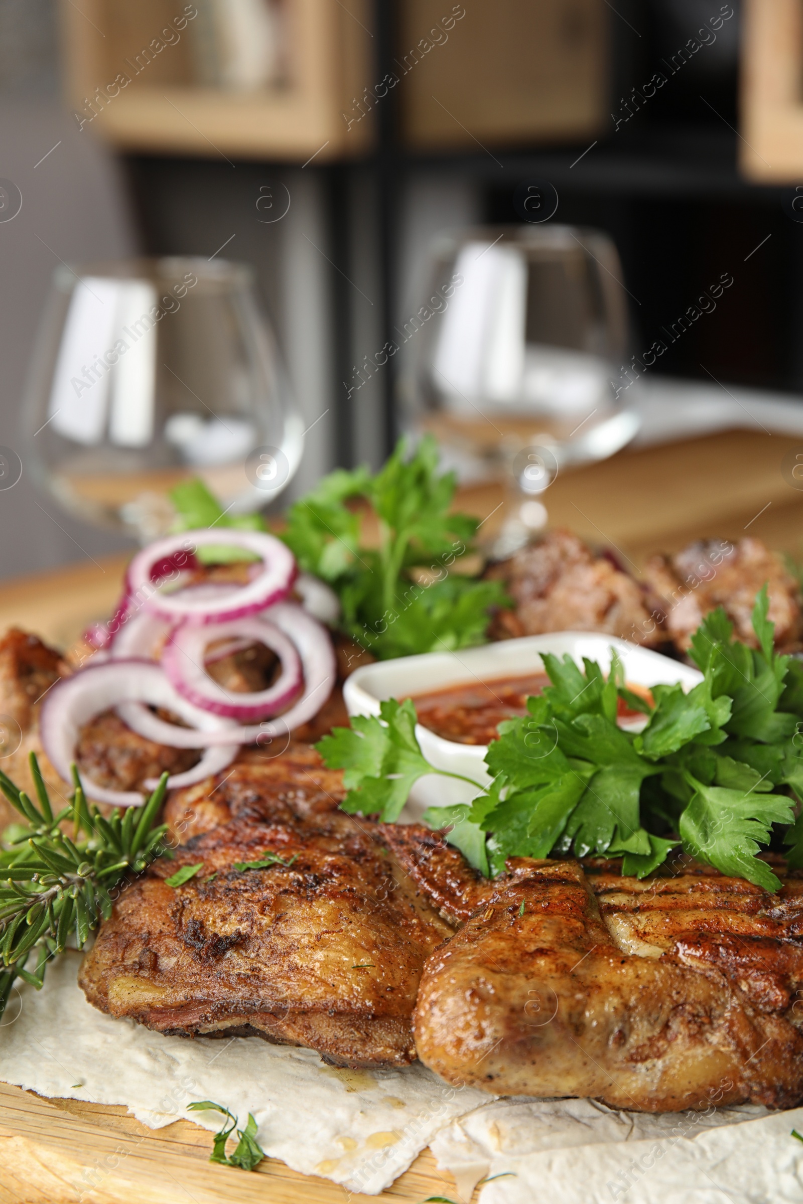 Photo of Delicious roasted chicken tobacco with herbal on wooden board, closeup