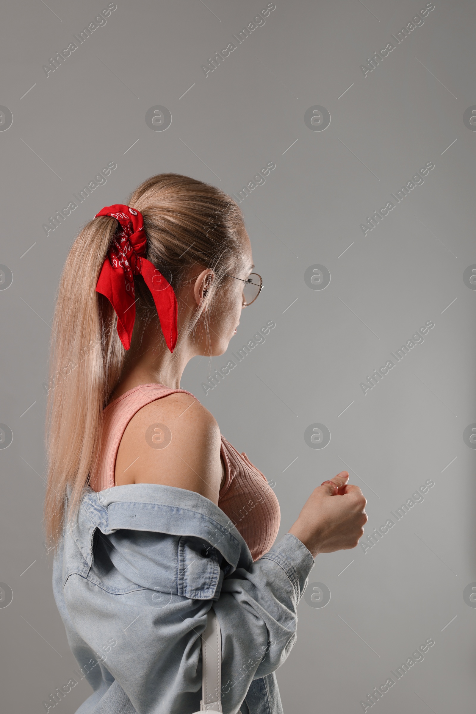 Photo of Woman with stylish red bandana on light grey background