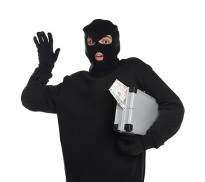 Emotional thief in balaclava with briefcase of money raising hand on white background