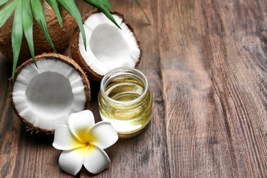 Beautiful composition with coconut oil and nuts on wooden background