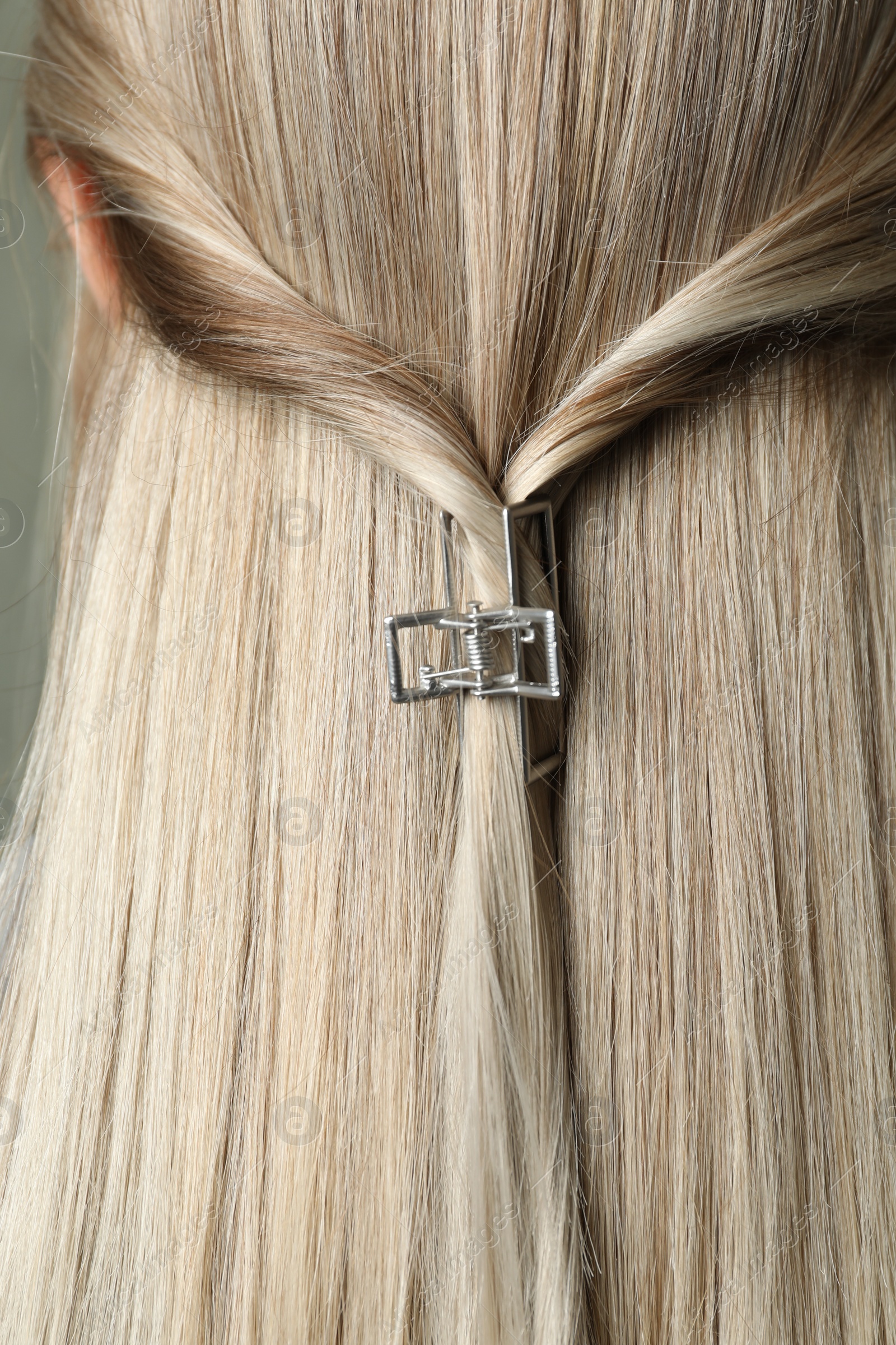 Photo of Young woman with beautiful hair claw, closeup
