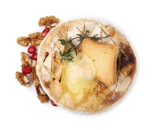 Photo of Tasty baked camembert with crouton, thyme, walnuts and pomegranate seeds isolated on white, top view