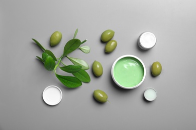 Flat lay composition with jars of body cream on grey background