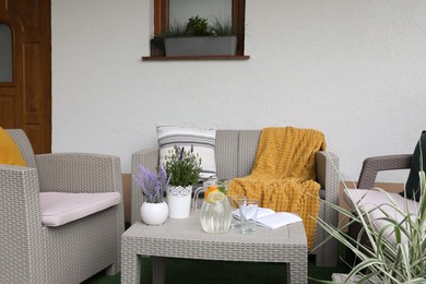Photo of Comfortable furniture with beautiful decor on outdoor terrace