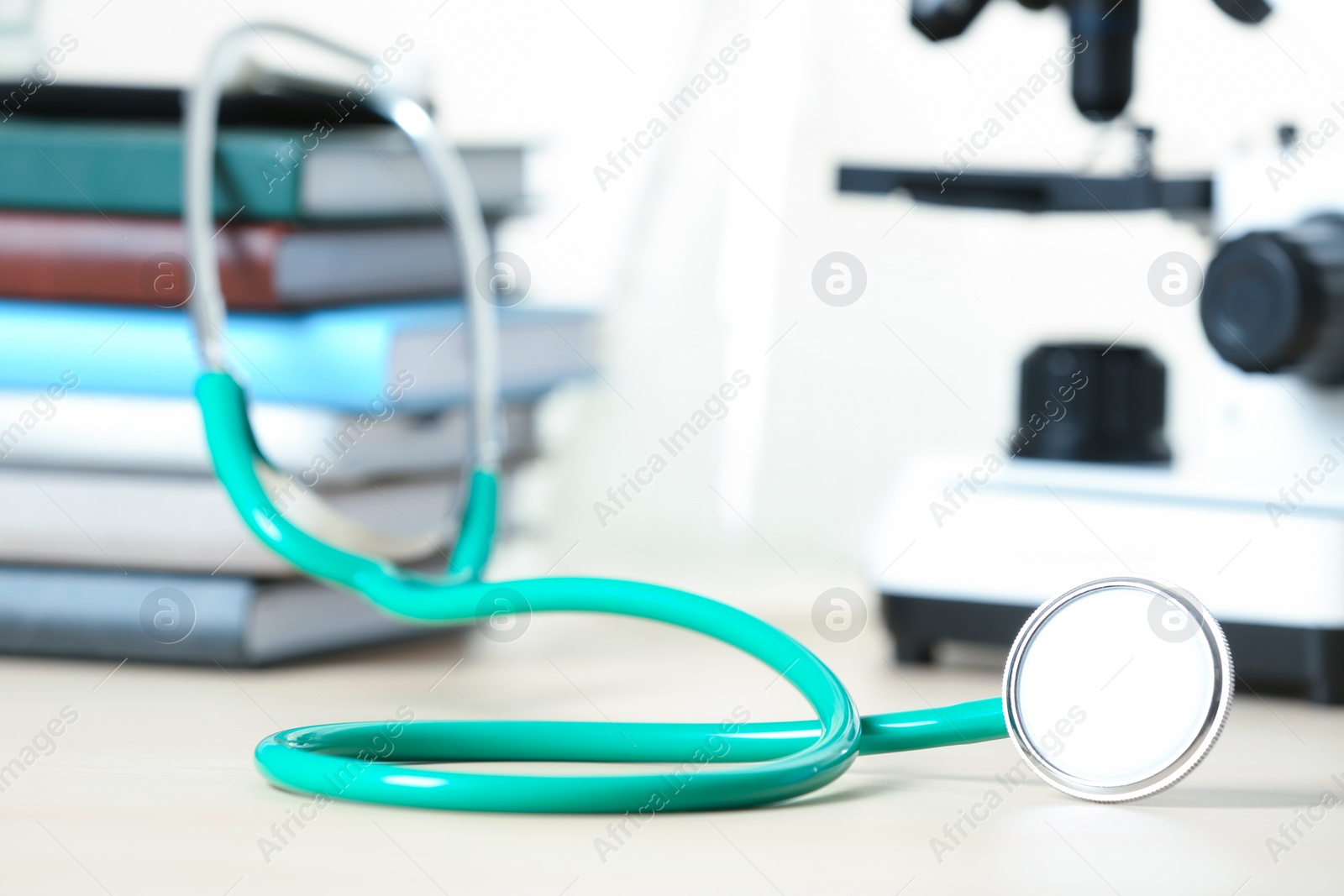 Photo of Stethoscope and books on table. Medical students stuff