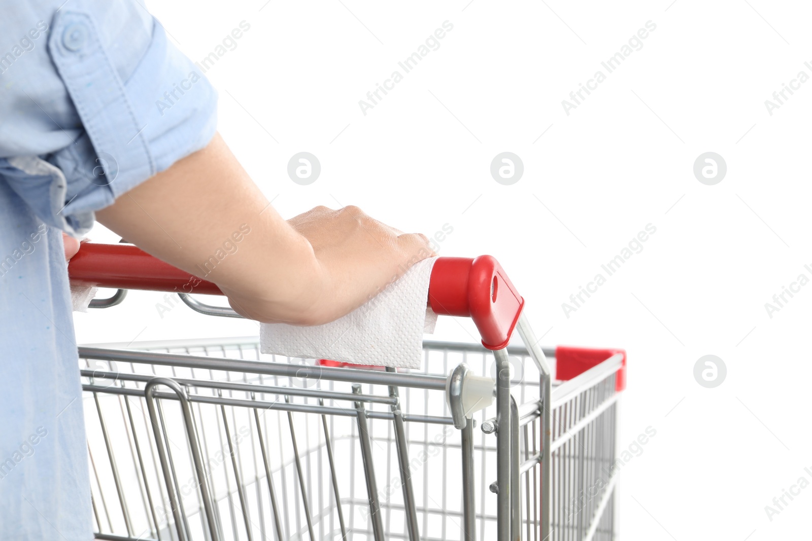 Photo of Woman holding shopping cart handle with tissue paper on white background, closeup