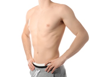 Young man with slim body on white background, closeup