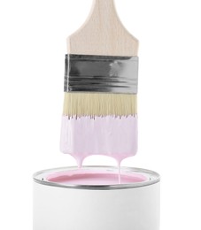 Brush with pink paint over can isolated on white