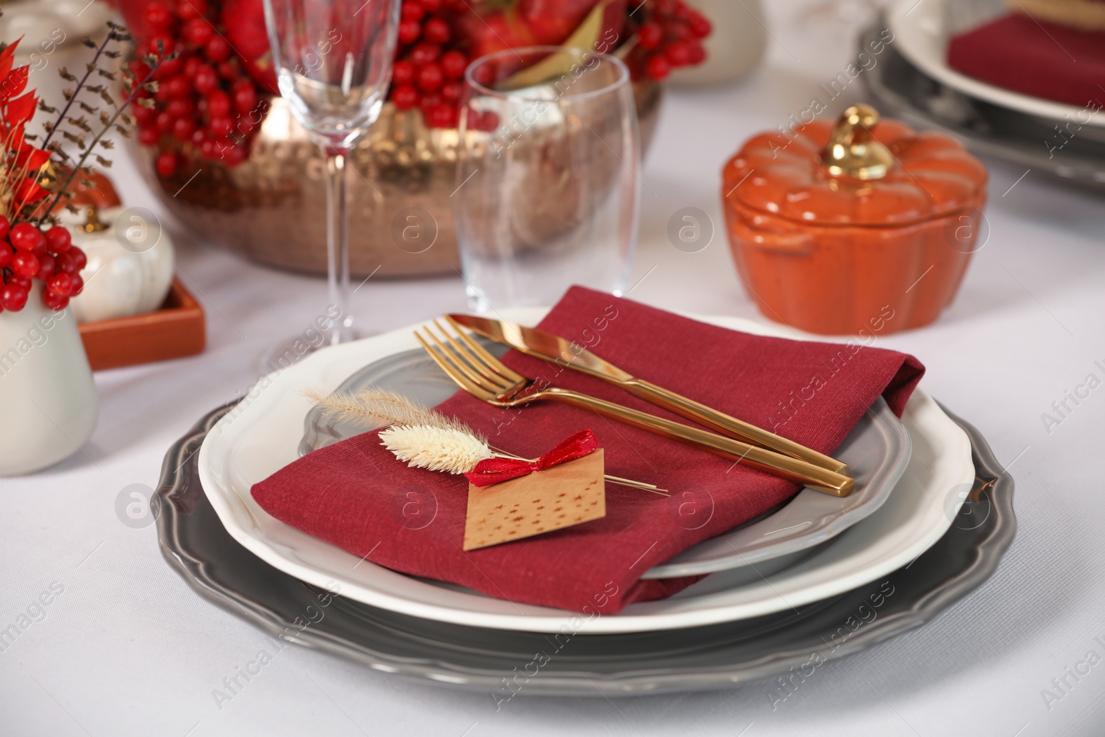 Photo of Elegant festive setting with autumn decor on table