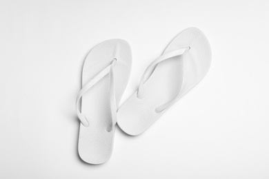 Pair of flip flops on white background, top view. Beach accessories