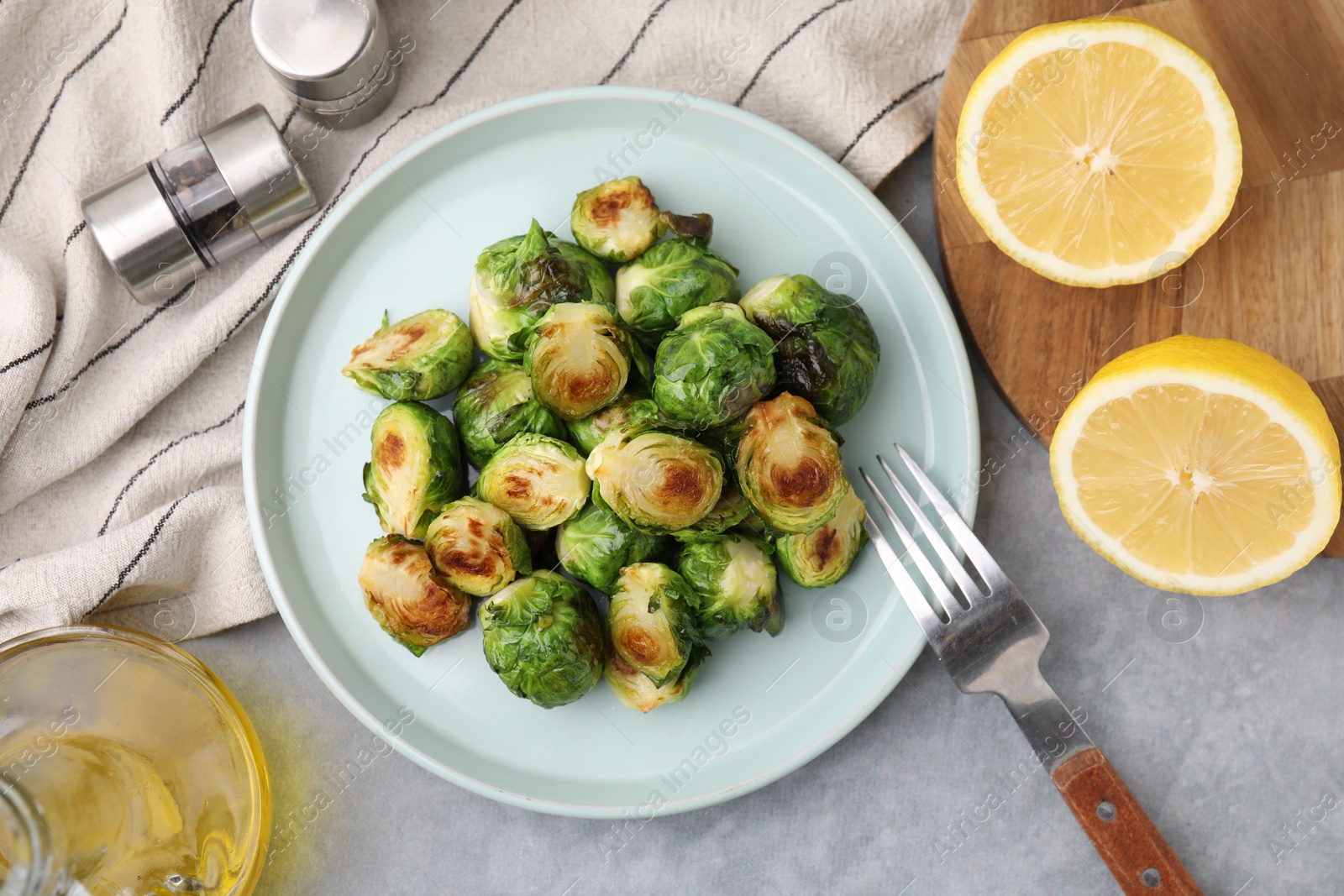 Photo of Delicious roasted Brussels sprouts served on grey table, top view