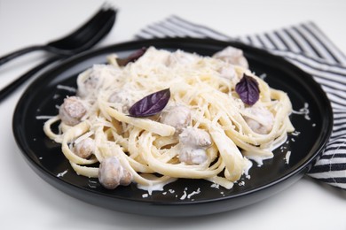 Photo of Delicious pasta with mushrooms served on white table, closeup