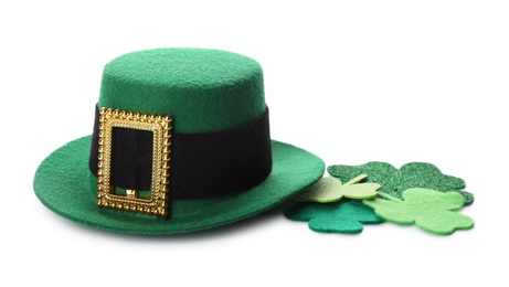 Photo of Leprechaun's hat and decorative clover leaves on white background. St. Patrick's day celebration