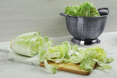 Chopped Chinese cabbage on white wooden kitchen table