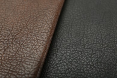 Photo of Brown and black types of leather as background, closeup