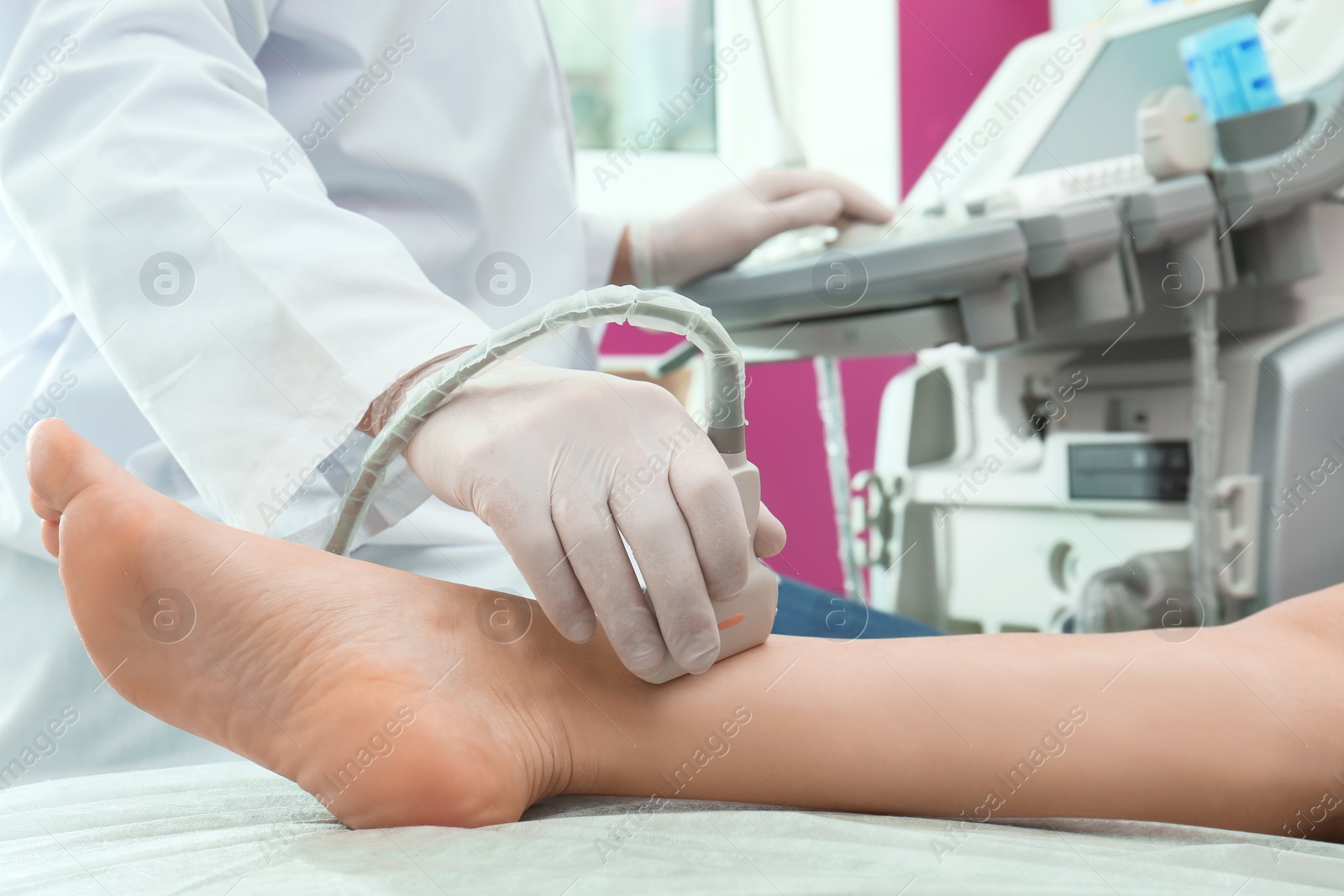 Photo of Doctor conducting ultrasound examination of patient's leg in clinic, closeup