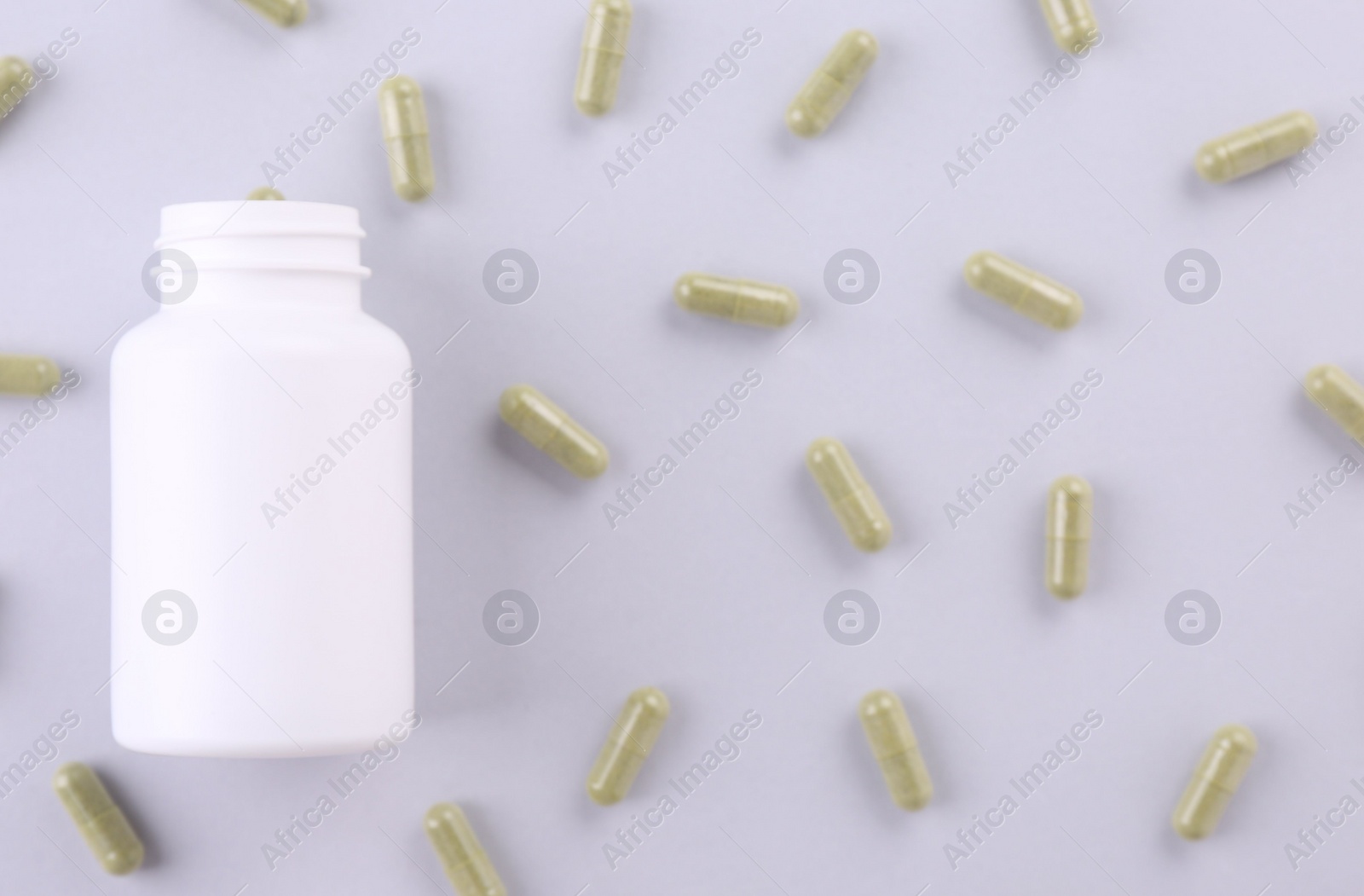 Photo of Jar with vitamin capsules on white background, flat lay