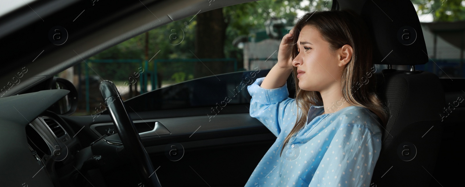 Image of Tired young woman driver's seat of modern car. Banner design