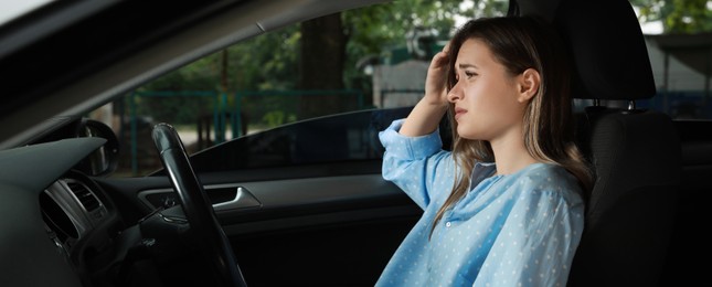 Image of Tired young woman driver's seat of modern car. Banner design