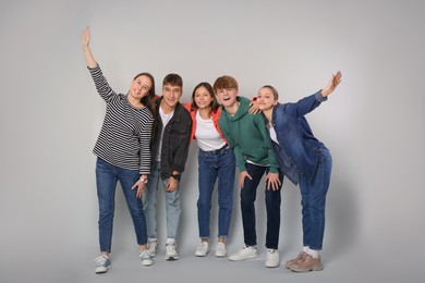 Photo of Group of happy teenagers on light grey background