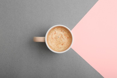 Photo of Cup of coffee on color background, top view