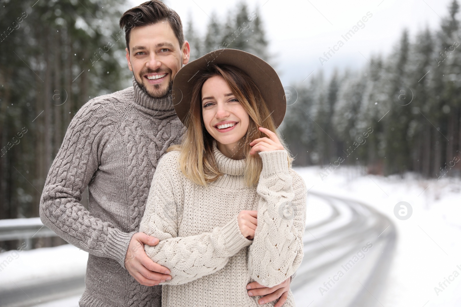 Photo of Cute couple outdoors on snowy day, space for text. Winter vacation