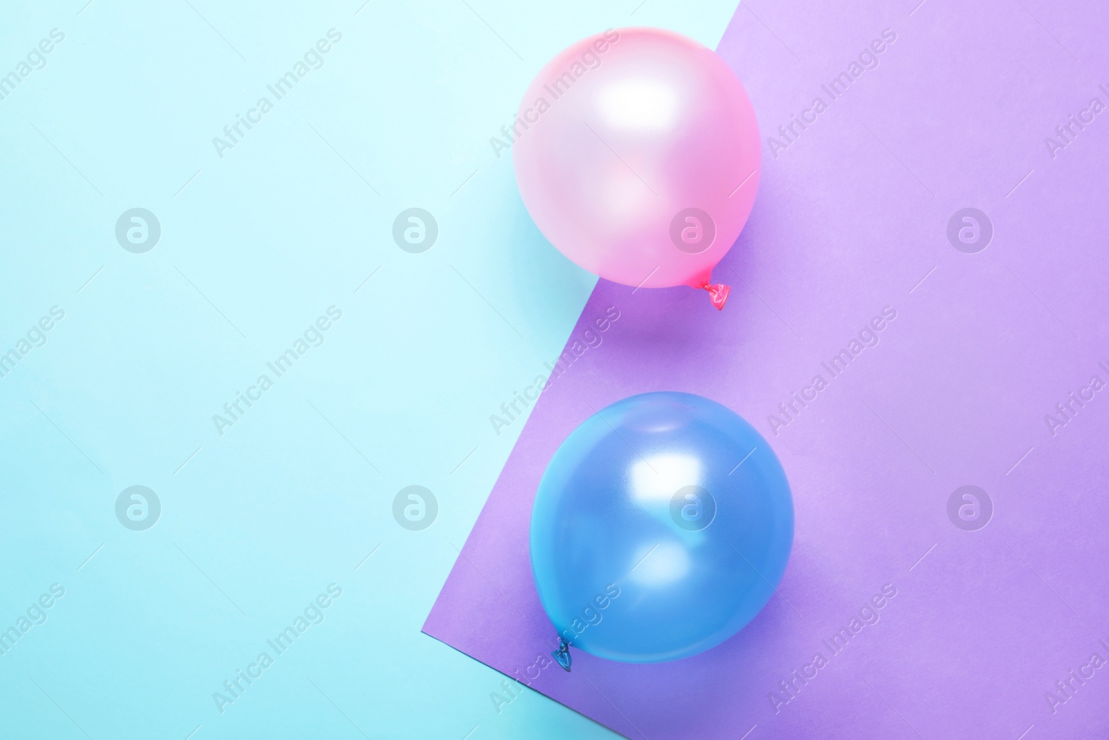 Photo of Flat lay composition with colorful balloons and space for text on color background