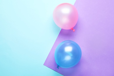 Photo of Flat lay composition with colorful balloons and space for text on color background