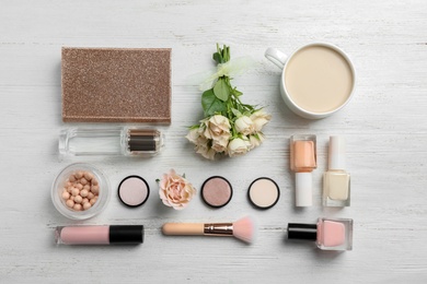 Photo of Flat lay composition with beautiful roses and cosmetics on wooden background