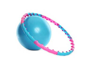 Photo of Hula hoop and exercise ball on white background