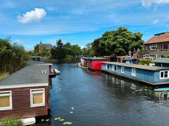 Beautiful view of canal with floating houses on sunny day