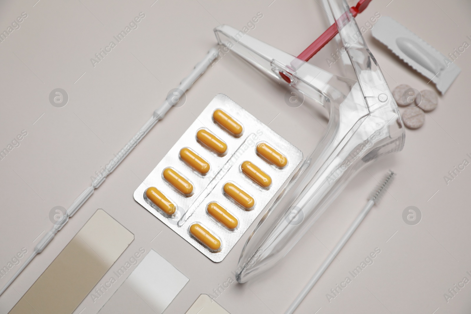 Photo of Sterile gynecological examination kit and medicaments on beige background