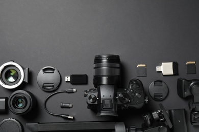 Photo of Flat lay composition with camera and video production equipment on black background. Space for text