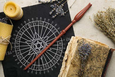 Flat lay composition with magic wand and divination cloth on light textured background