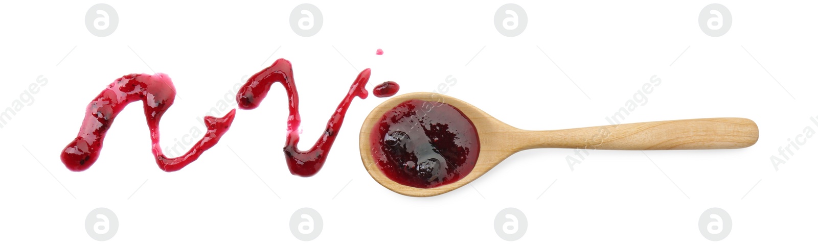 Photo of Tasty sweet jam and spoon isolated on white, top view