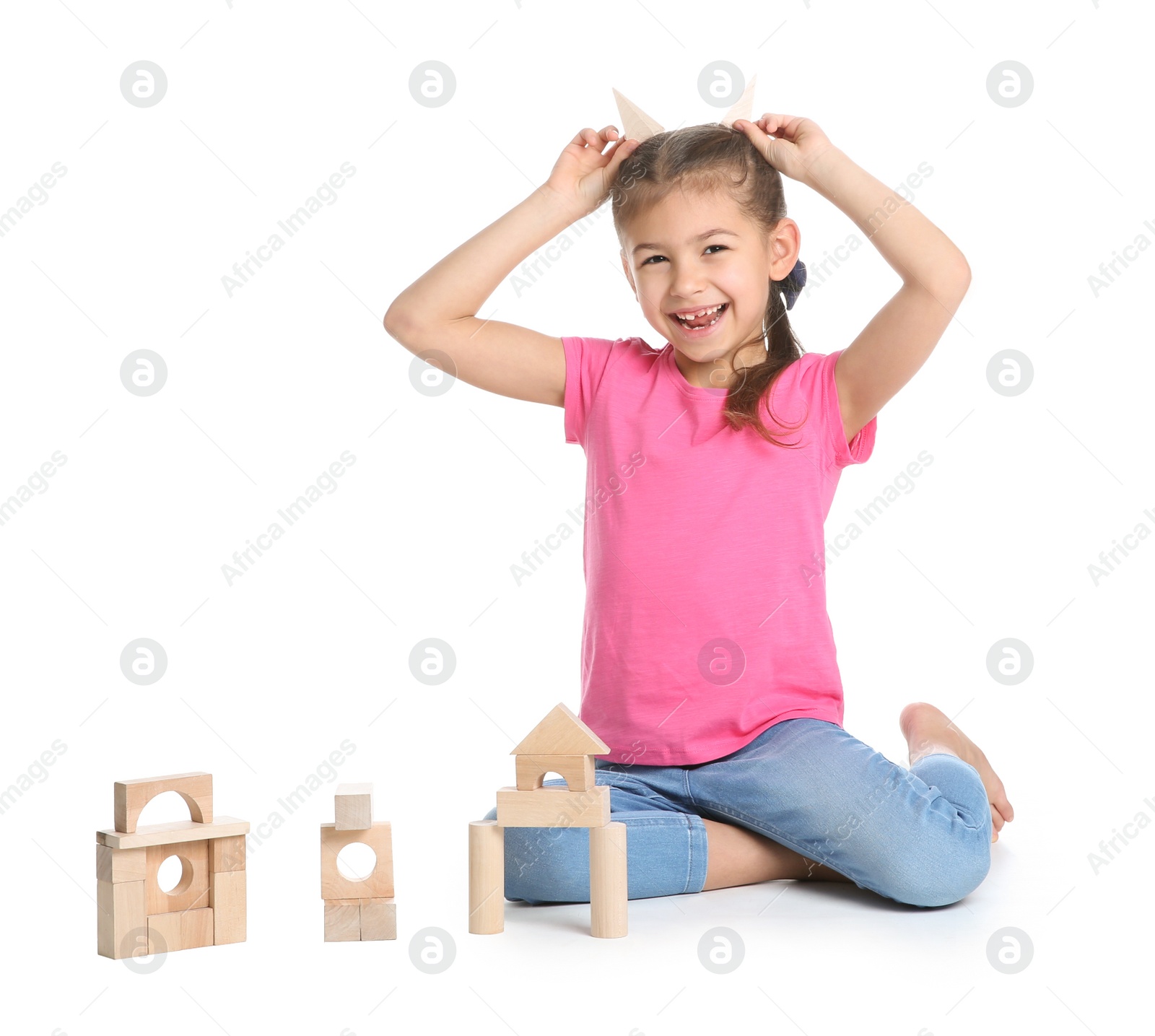 Photo of Cute child playing with wooden blocks on white background