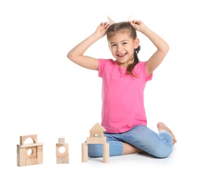 Photo of Cute child playing with wooden blocks on white background