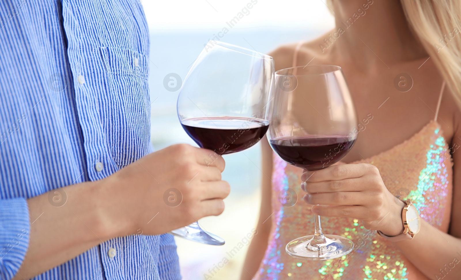 Photo of Young romantic couple with glasses of red wine outdoors