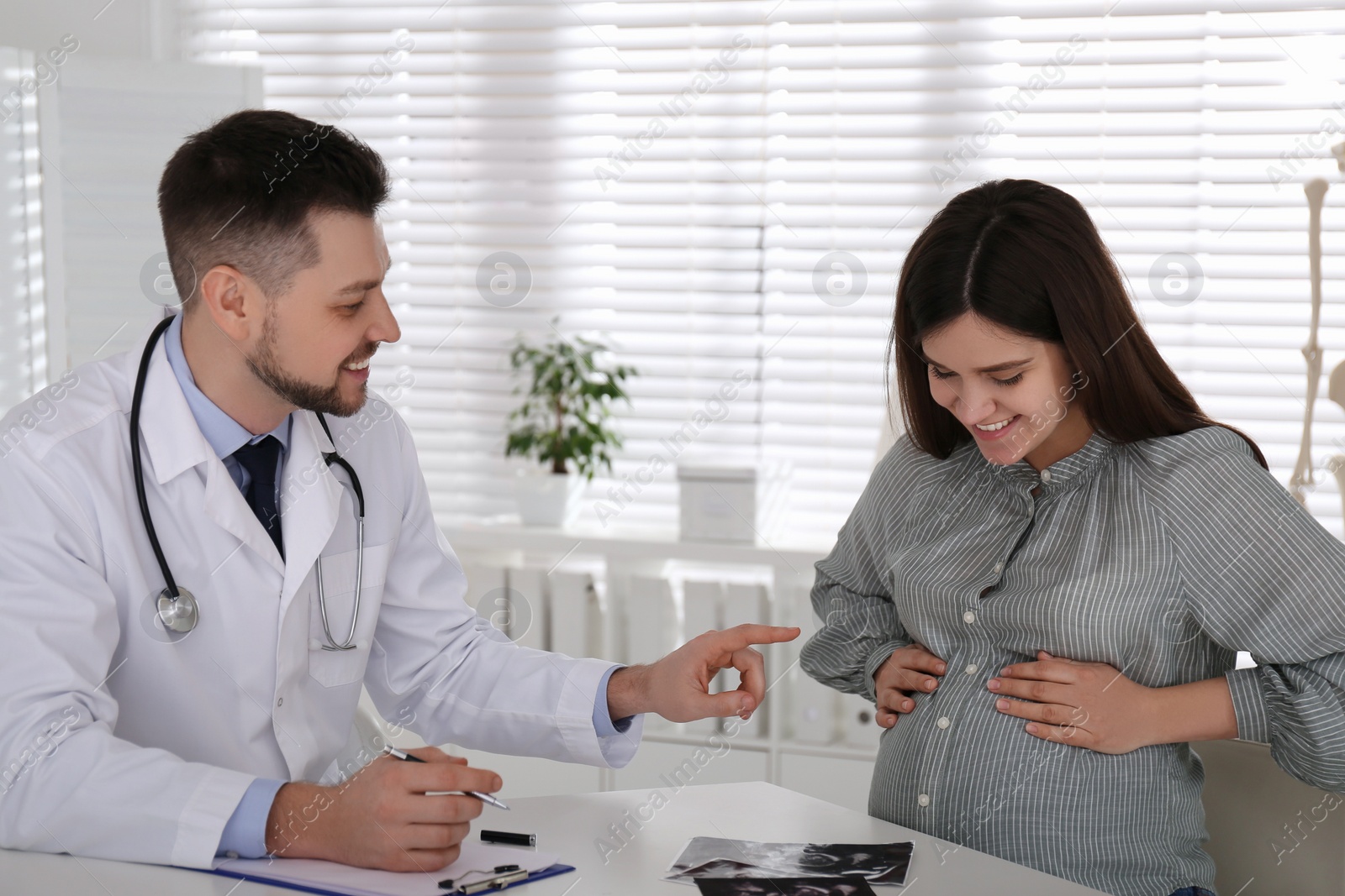 Photo of Pregnant woman having appointment at gynecologist office