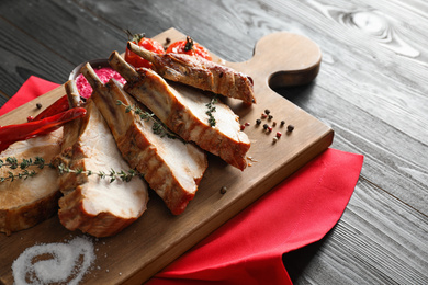 Delicious roasted ribs served on wooden table