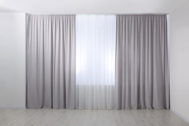 Light grey window curtains and white tulle indoors