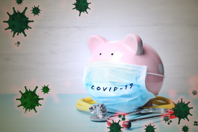 Image of Piggy bank with medical mask. Money saving during coronavirus outbreak