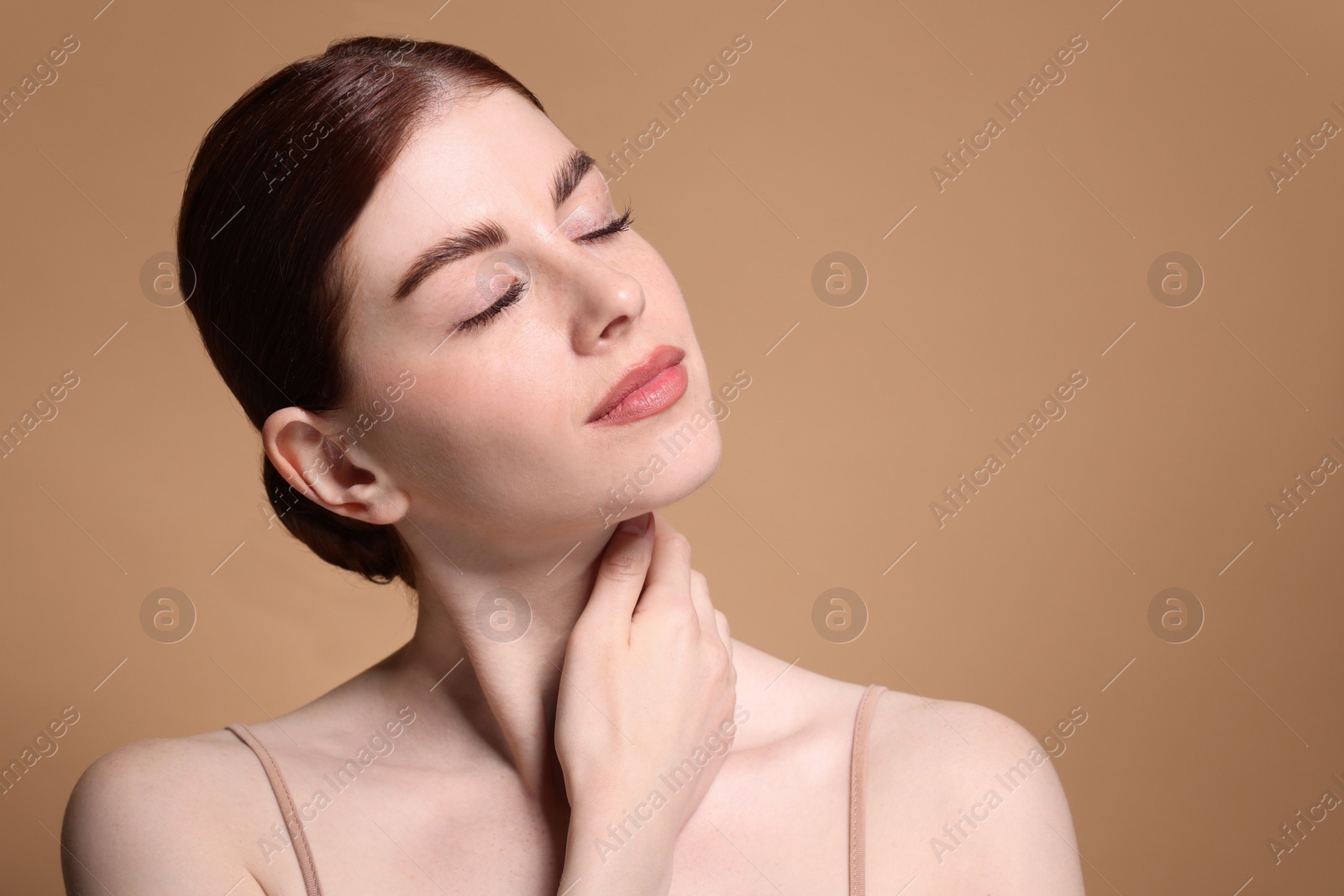 Photo of Portrait of beautiful woman on beige background, closeup. Space for text