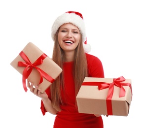 Photo of Happy young woman in Santa hat with Christmas gifts on white background