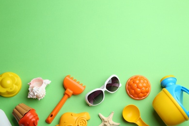 Flat lay composition with bright beach toys on color background. Space for text