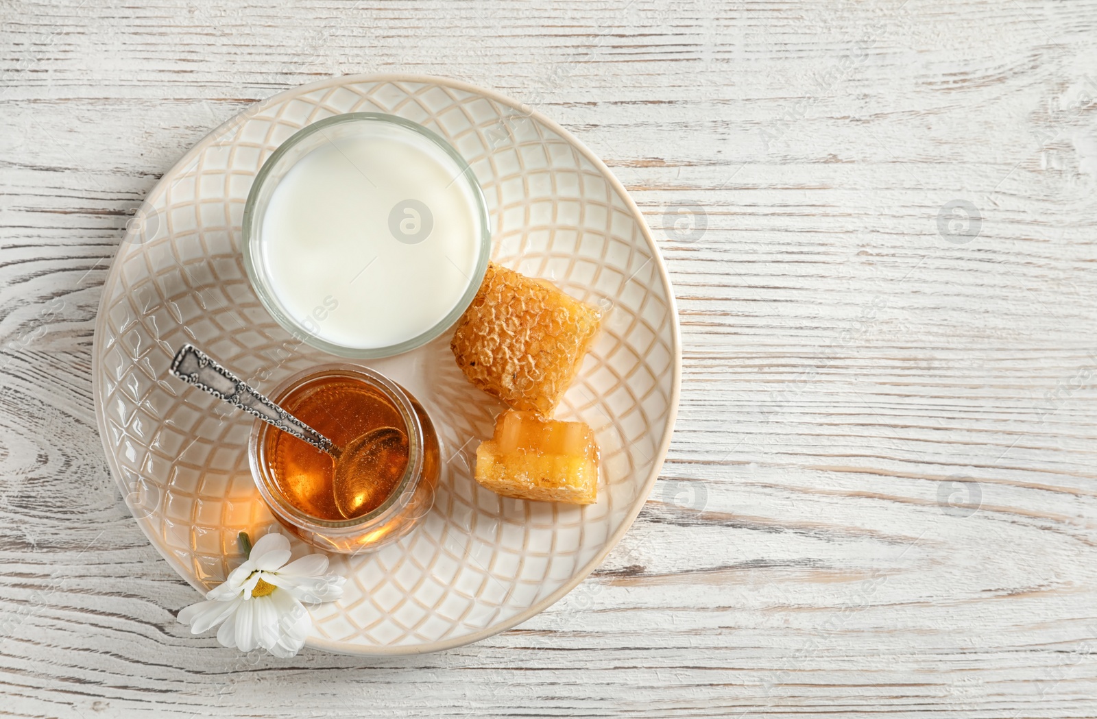 Photo of Beautiful composition with milk and honey on wooden background, top view