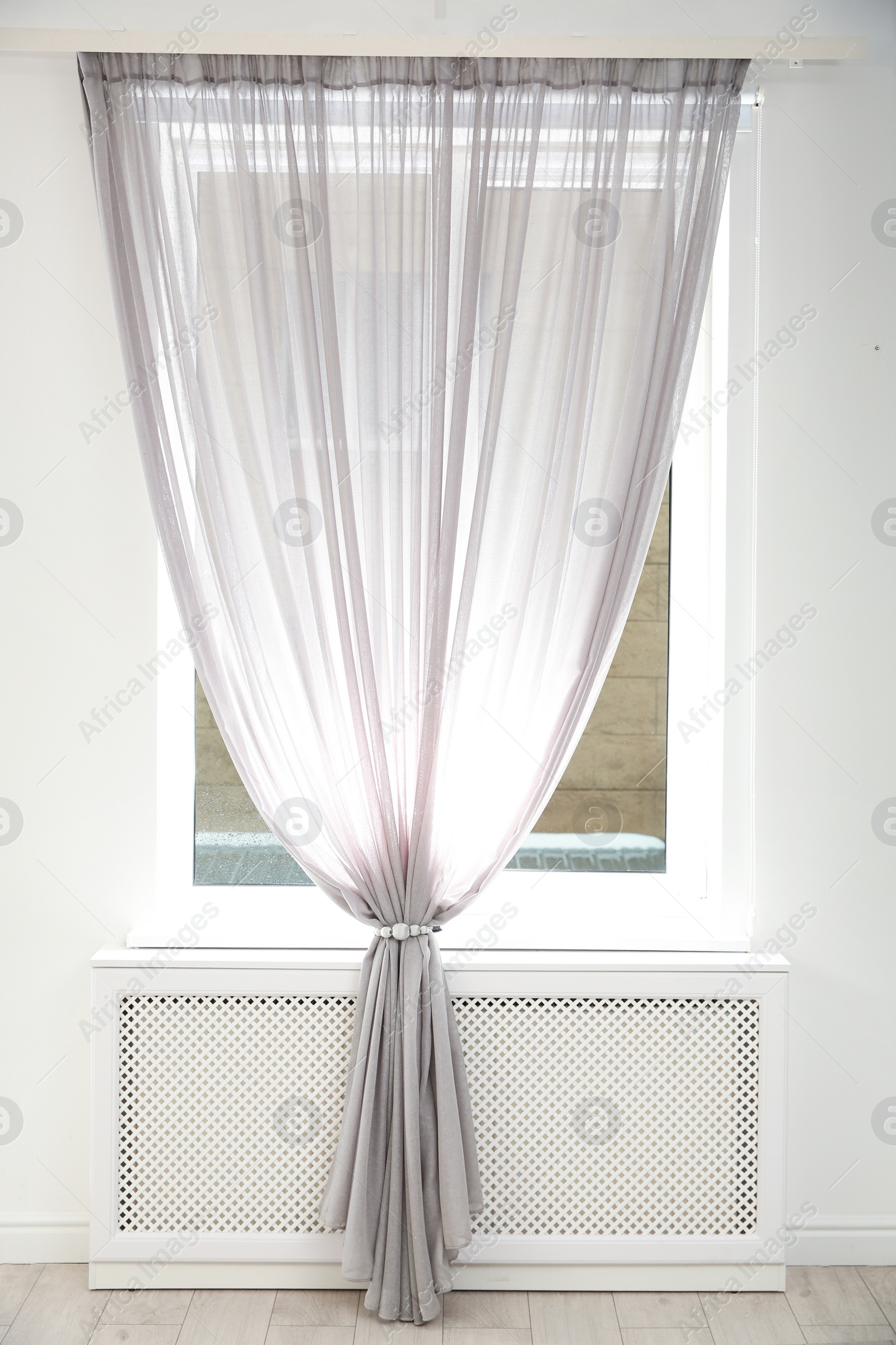 Photo of Modern window with curtain in room. Home interior